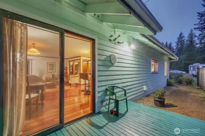 Second view of side deck with manicured path leading to front yard.