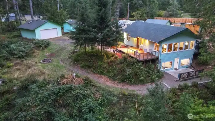 Drone view of the rear of the home and out buildings.