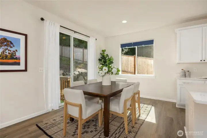 Spacious dining area overlooks the back and side yards. Light-blocking blinds are featured throughout the home, enabling lazy weekend mornings or movie nights during those long summer days.