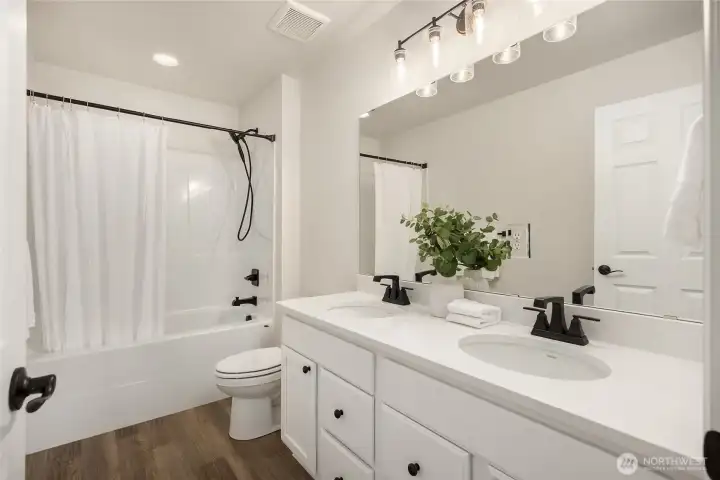 Large upper bath also features double sinks and large tub with shower.