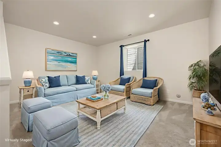 Yet another bonus or flexible use space is located on the lower level. Virtually staged as a living area, this space would be a great home office, playroom, yoga area, or even a guest space.