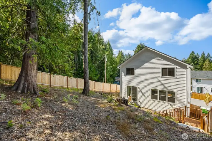 The gently sloping backyard is ready for your ideas. . . Gazebo? Terraced deck? Planter boxes?