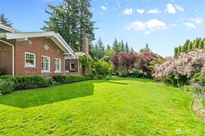 The lush, mature landscaping surrounding this property creates a picturesque setting for this charming 1917 character home. There are also a couple orchard areas with fruit trees.