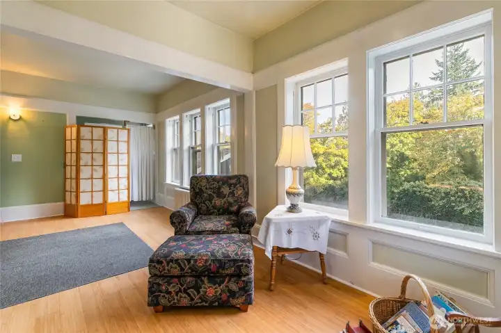 This large room off of the entryway was the original office for the Lumber Mill. To the left, you'll find the original wall safe, as this is where employees of the mill came to pick up their checks. This photo truly exemplifies the large trim work seen throughout the home that is a rare find these days! This room and the hallway have bamboo flooring.