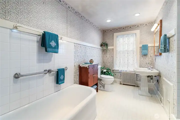 Main floor bathroom with separate tub and shower.