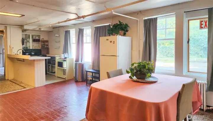 Basement ADU Dining area and kitchen. There is another area with a couple couches to the left of the kitchen.