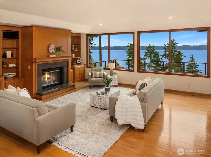 A warm and inviting living area with custom built-ins, fireplace and a majestic view framed by Pella windows!