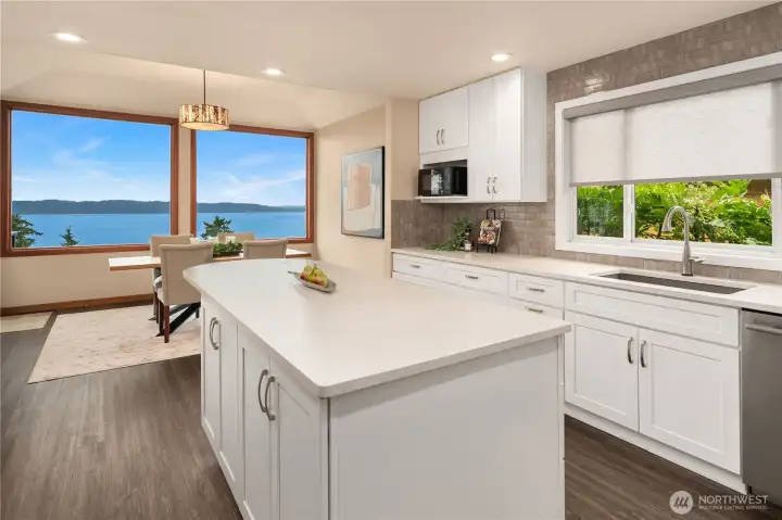 A large solid slab island and spacious counters makes meal prep and serving so easy! Ample storage abounds.