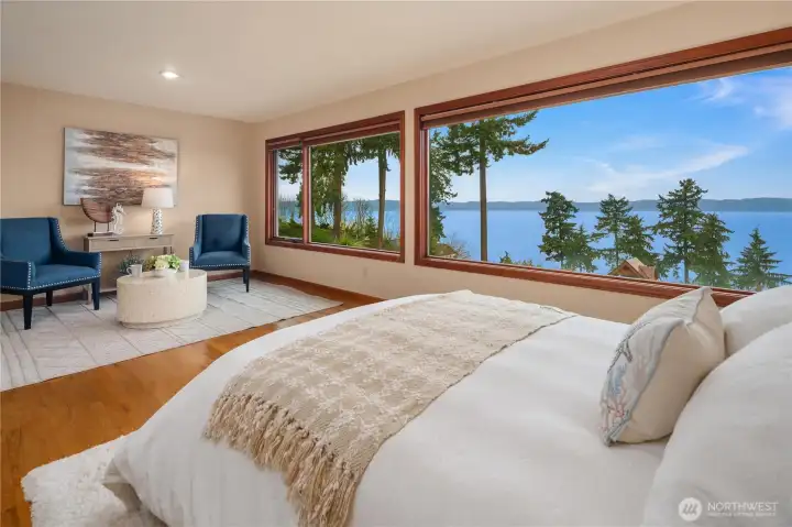 What a relaxing main bedroom to slumber and wake up in! Enjoy a morning coffee, or some stretching all while absorbing the serene water and island view.