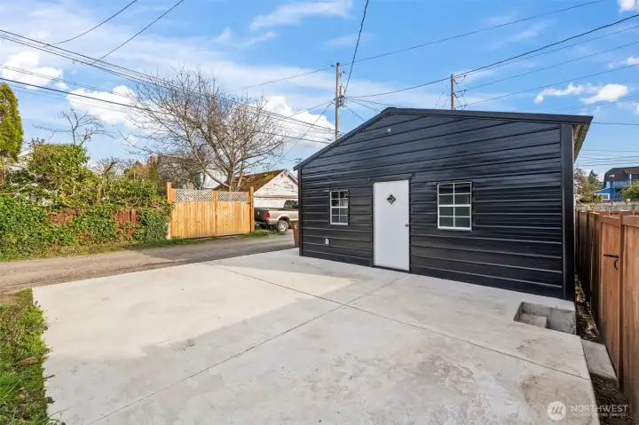 Large Parking pad off of rear alley and new oversized two car garage/shop
