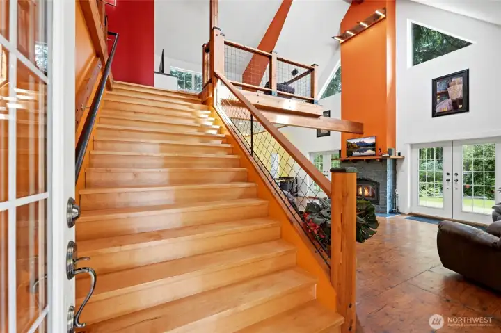 Grand 6' wide staircase heading up to the loft & primary suite.