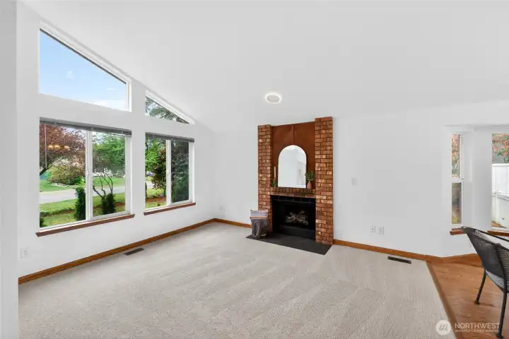 Light and bright living room with wood burning fireplace