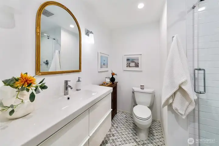 Updated en-suite 3/4 bath dressed in marble.