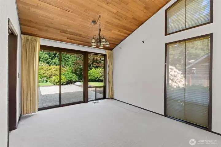Spacious dining room featuring direct access to a large patio, perfect for seasonal outdoor entertaining. The room is flooded with abundant natural light.