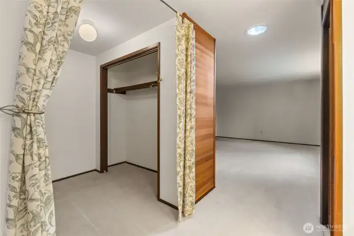 Spacious primary bathroom featuring a large, walk-in closet with ample room for additional storage.