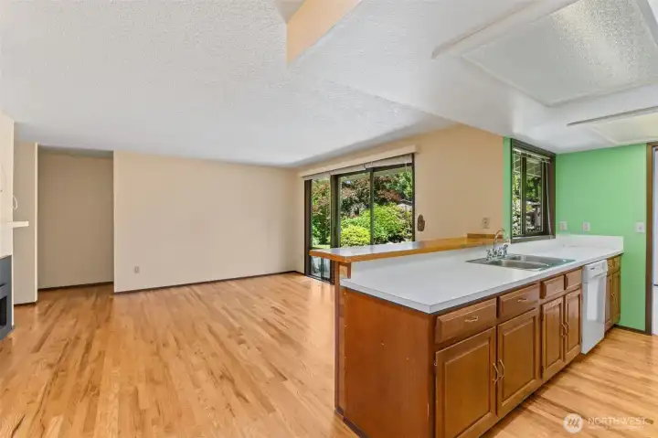 Bright, open-concept family room featuring a seamless transition from the kitchen and convenient direct access to the back patio.