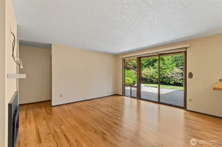 View of the family room looking toward the back patio access and the entry to the two rear bedrooms.