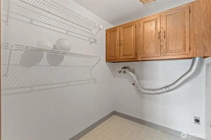 Spacious laundry room with ample storage, ready for your high-efficiency appliances.