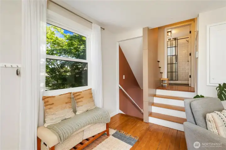 Up to the primary bedroom and remodeled bathroom. Down to the kitchen and access to the fully fenced yard.