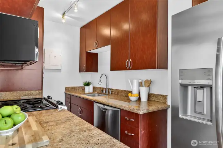 Enjoy a full-sized fridge, double dishwasher, full sized range, & microwave, stone counters, and ample storage.