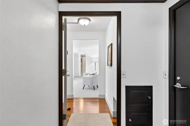 The large entry features a long closet, and a cut-out for the retired milk delivery service- a nod to the buildings history.
