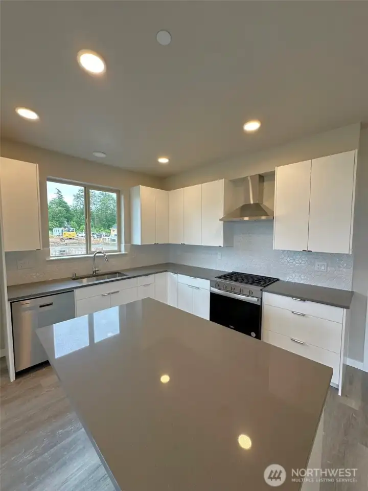 Subject property. Locally manufactured cabinets throughout the home & quartz counters & stainless appliance package includes fridge