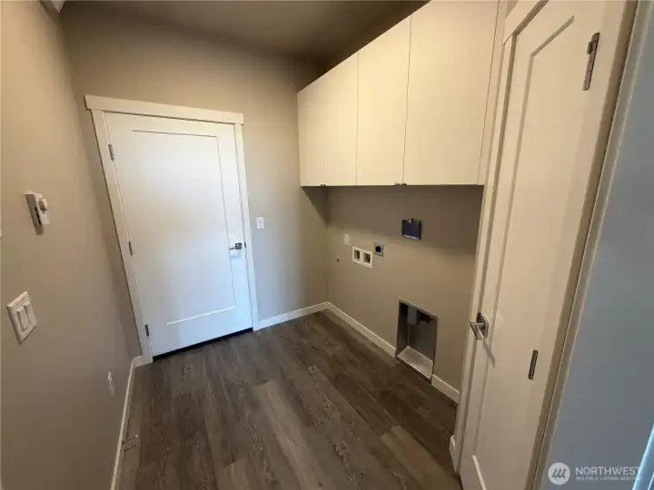 Subject property. Laundry room located looking towards the door to the garage