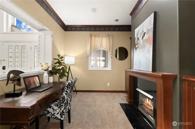 A peaceful room for a home office on the main level with a 2nd fireplace.