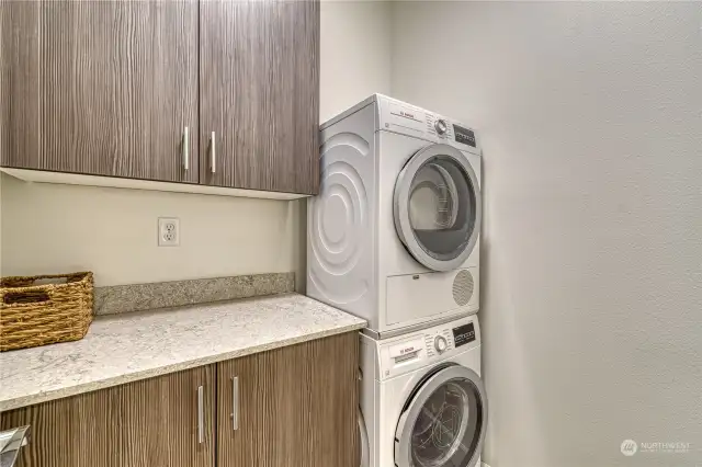 Spacious laundry room with lots of cabinets and counter space as well.