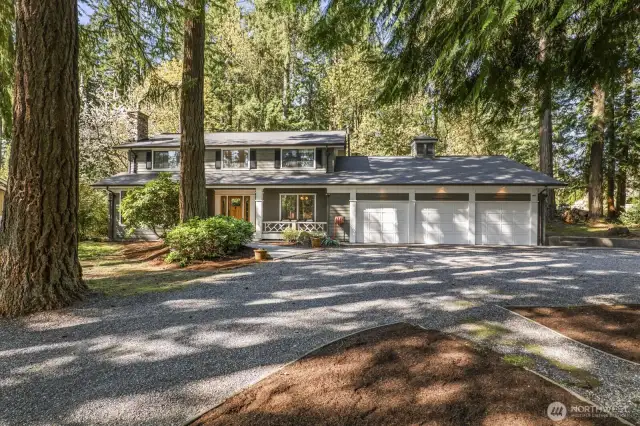 The circular drive leads toward the front covered Ironwood deck with Mahogany front door.