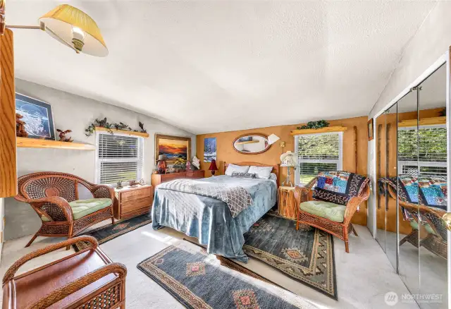 Spacious bedroom with a good sized, mirrored closet.