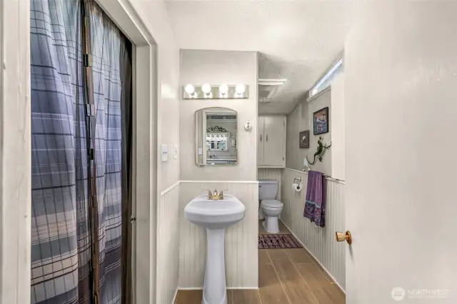 Updated bathroom with newer laminate flooring and a walk-in shower.