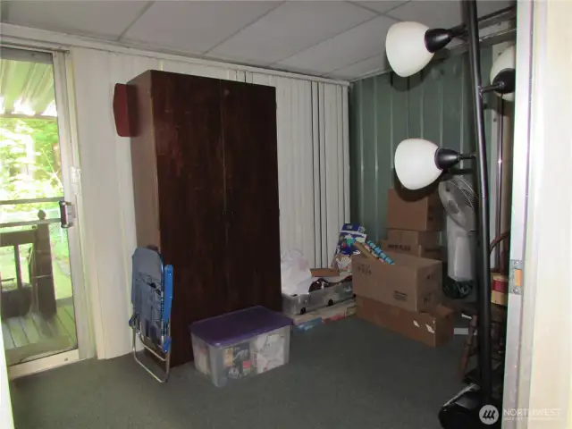 INSIDE ENCLOSED ROOM OFF HALL, SLIDING GLASS DOOR TO COVERED DECK ON LEFT, ALL GLASS WALL BEHIND BLINDS.