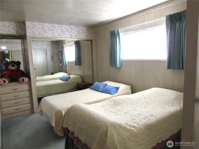 PRIMARY BEDROOM IS SPACIOUS WITH BUILT-IN DRAWERS AND CLSET .