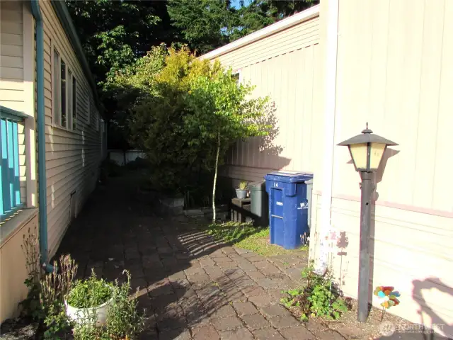 PAVER WALKWAY TO LEFT OF BACK DOOR IS ACCESS TO FRONT, LARGE COVERED DECK ON LAKE SIDE OF HOME.