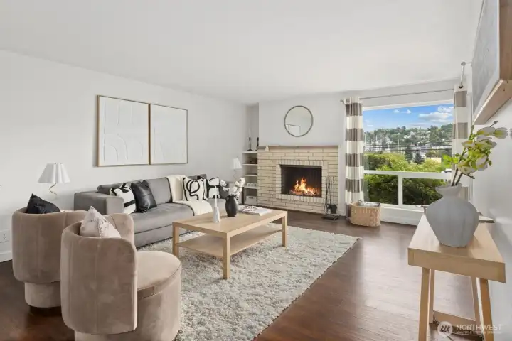 Spacious living room featuring wood burning fireplace, radiant heating, and terrestrial views.
