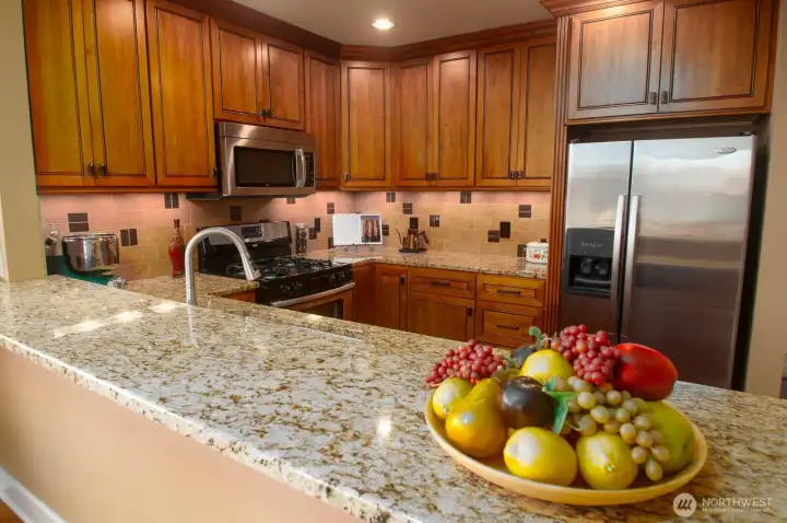 Breakfast bar can easily accommodate four stools for guests to eat or just chat with the chef during meal prep.
