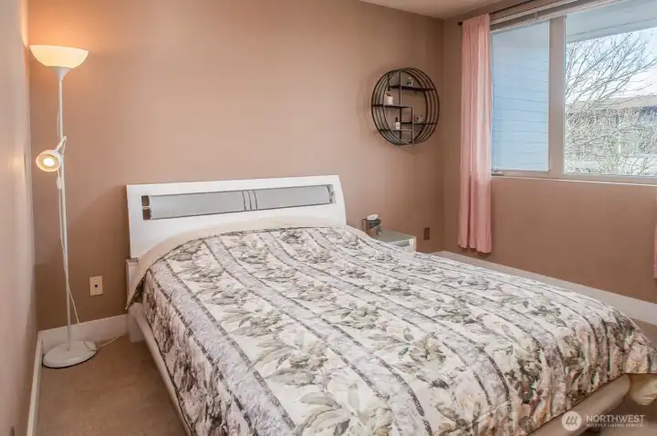 Primary bedroom overlooks outside balcony.