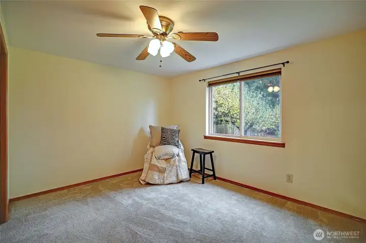Bedroom. Rear garden view. Ceiling fan with remote. Supplemental wall heat.
