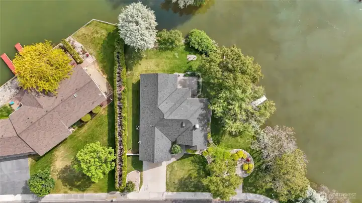 Aerial view showcasing private waterfront setting, dock access, and large landscaped lot Aerial view showcasing private waterfront setting, dock access, and large landscaped lot