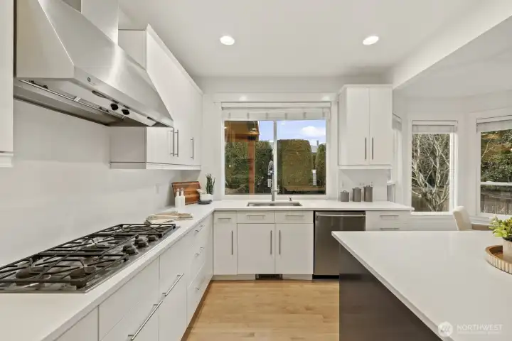 New quartz counters and solid maple cabinets sparkle in abundant natural light pouring in.