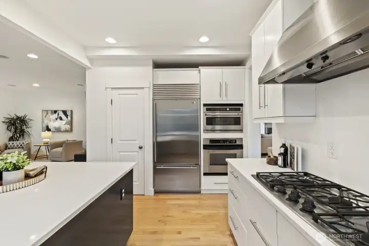 Chefs will love to cook with the high-end stainless steel appliances! Just to the left of the fridge is a roomy pantry, as well.
