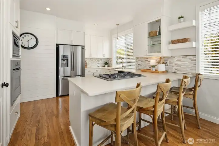 Totally Remodeled kitchen with newer appliances, white cabinetry and quartz countertop