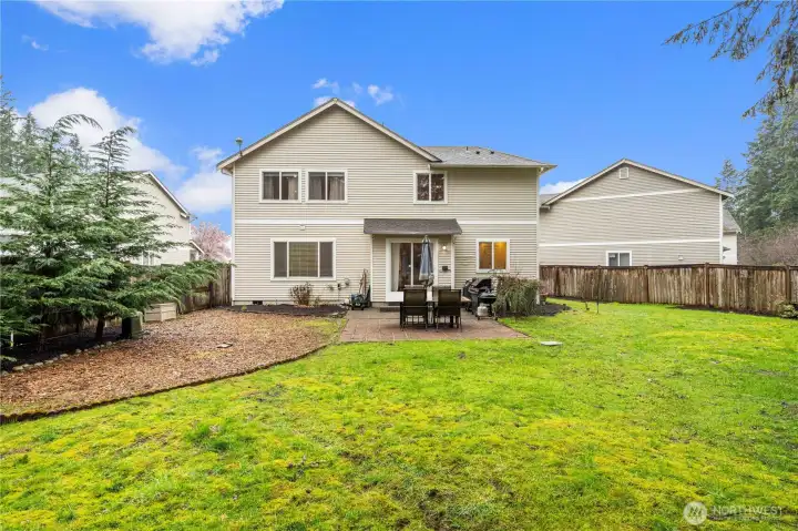 Large backyard with fresh landscaping and recently reseeded lawn, offering a great space for outdoor enjoyment and entertaining.