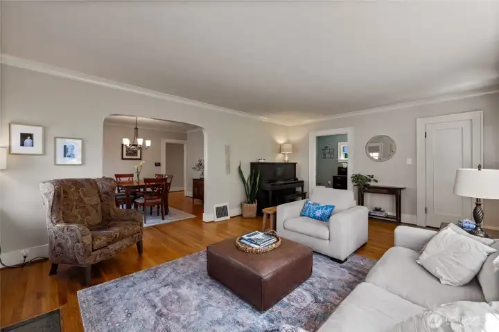 Curved archway opens the living room to the dining room.  Entry coat closet on the right with office/bedroom #1 to the left, has a glass panel door for a nice open feeling.
