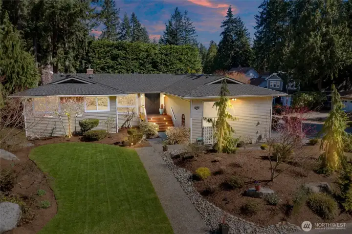Twilight hours with outdoor lighting accentuating the award winning landscaped yard Twilight hours with outdoor lighting accentuating the award winning landscaped yard