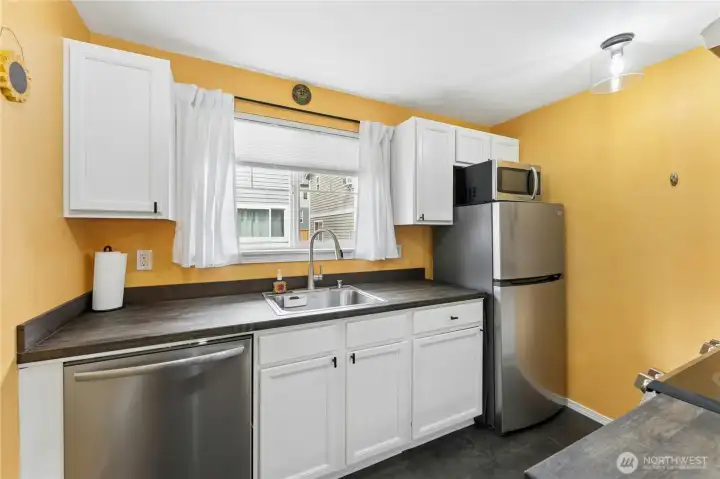 The kitchen is updated with new butcher block countertops and a new dishwasher.