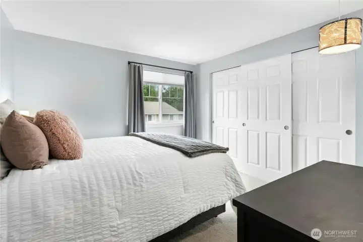The spacious primary bedroom features oversized closets, providing abundant storage and everyday convenience.