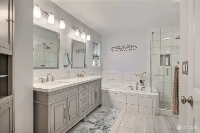 Gorgeous update primary bathroom with tile floors, new vanity with undermount sinks & quartz countertops, lg soaking tub, big tile shower, large walk-in closet. Beautiful!