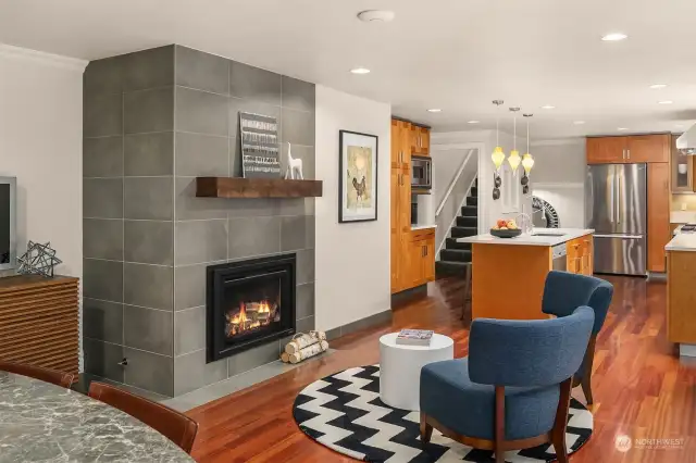 Stunning custom grey tile fireplace is a modern touch to the more traditional design elements, and provides a quiet respite to an other wise busy room.